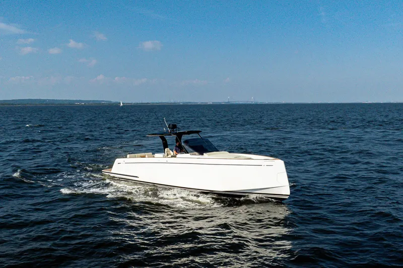Slide: The Image of 2025 Pardo Yachts P38 cruising on open water under a clear blue sky. - 1