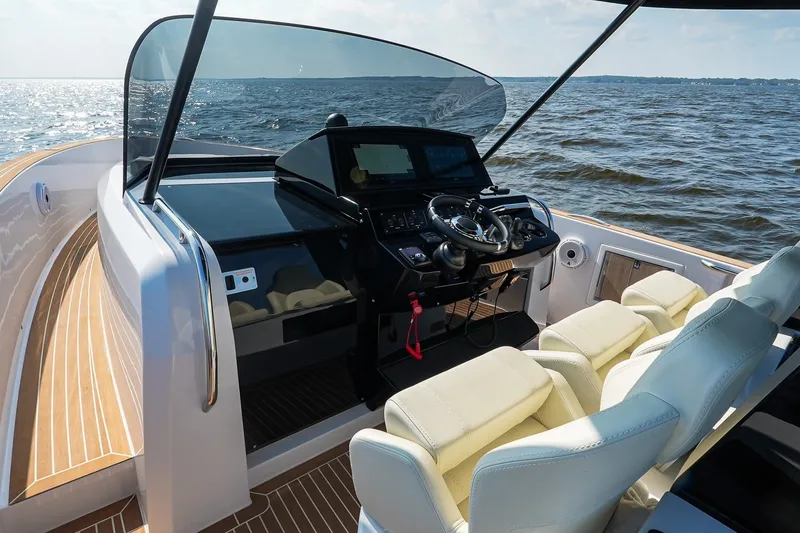 Slide: The Image of Luxurious 2025 Pardo Yachts P38 cockpit with modern controls and plush seating on open water. - 21