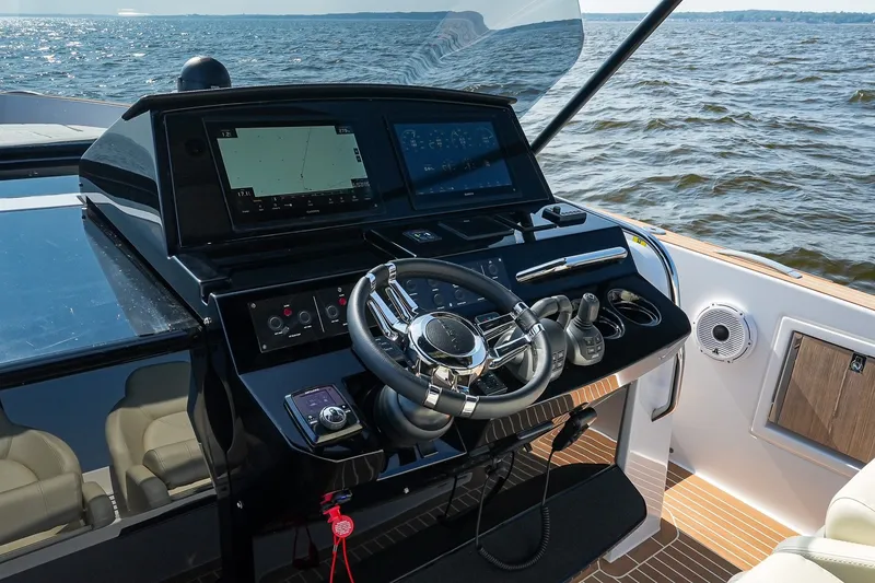 Slide: The Image of Helm of 2025 Pardo Yachts P38 with advanced navigation systems on open water. - 22