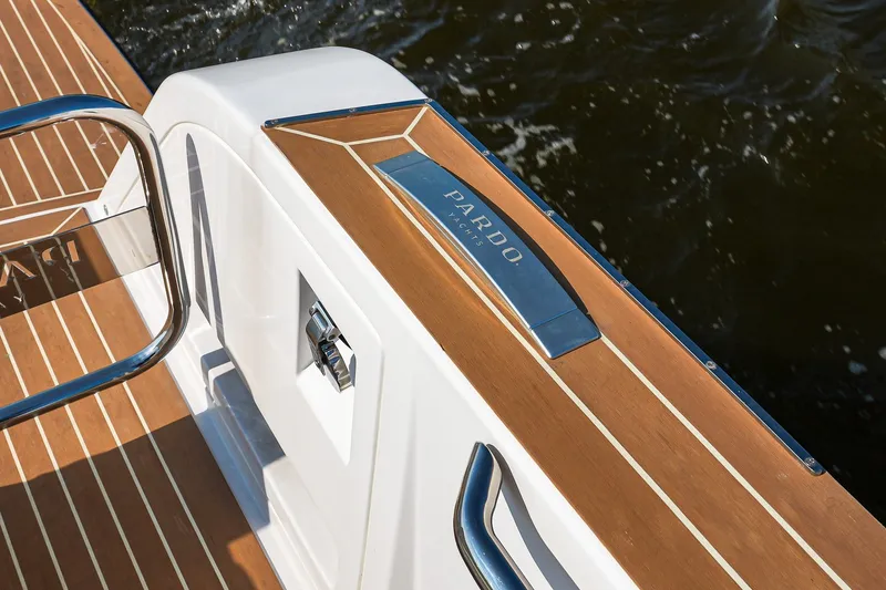 Slide: The Image of 2025 Pardo Yachts P38 deck with sleek wood finish and chrome details. - 10