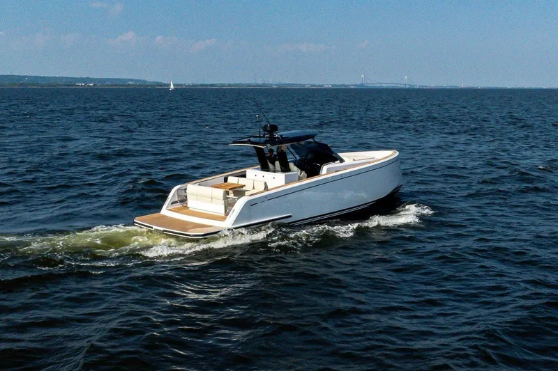 Slide: The Image of A sleek, modern motorboat cruising on open water. It features a spacious deck and stylish cabin. - 5