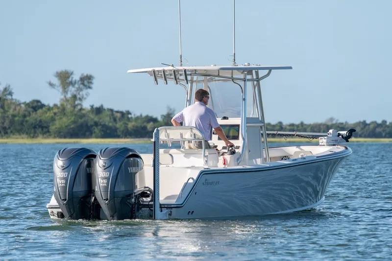 Slide: The Image of 2023 Stuart 27 Center Console boat with dual Yamaha engines on calm water. - 6