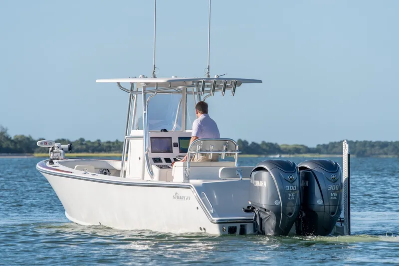 Slide: The Image of 2023 Stuart 27 Center Console boat with dual Yamaha engines on calm water. - 10