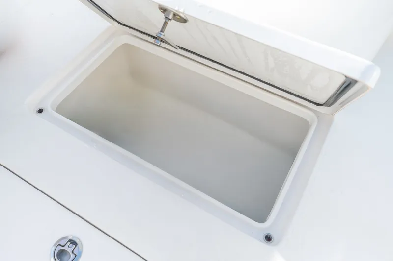 Slide: The Image of Open storage compartment on 2023 Stuart 27 Center Console boat. - 37