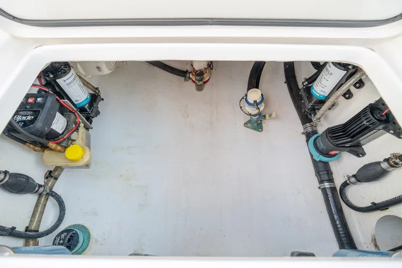 Slide: The Image of 2023 Stuart 27 Center Console boat interior showing mechanical components and wiring. - 22