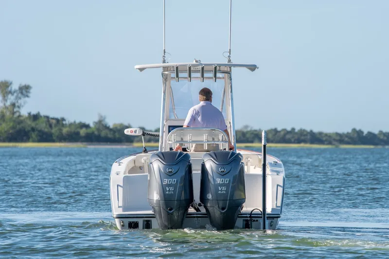 Slide: The Image of 2023 Stuart 27 Center Console boat with dual 300 V6 engines on water. - 4