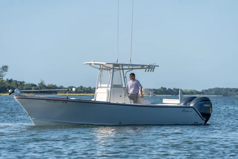 Slide: The Image of 2023 Stuart 27 Center Console boat on water with person at helm. - 9