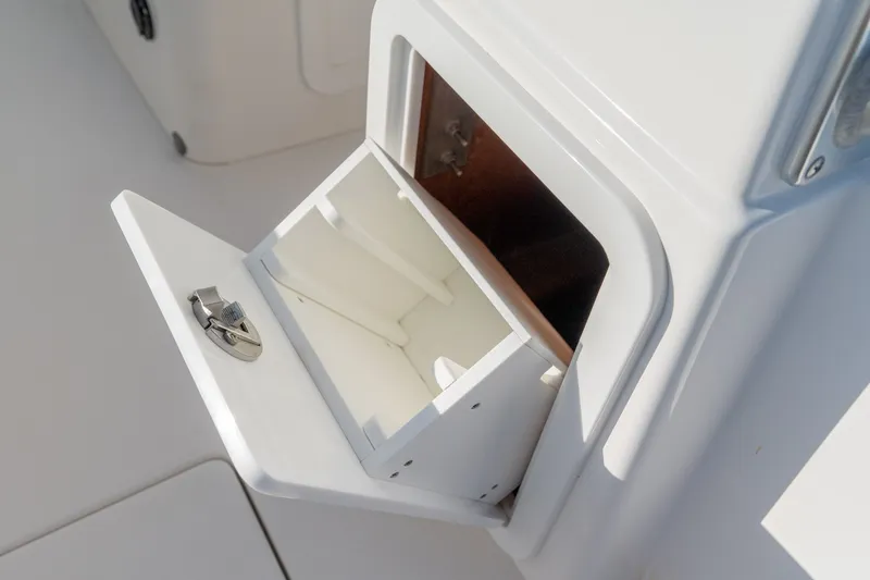 Slide: The Image of Open storage compartment on 2023 Stuart 27 Center Console boat. - 39