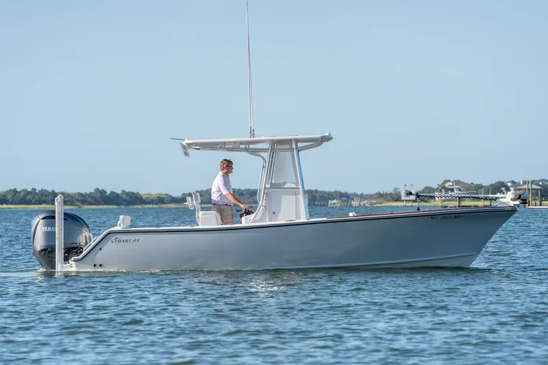The Image of 2023 Stuart 27 Center Console boat cruising on calm water with a Yamaha engine. - 0