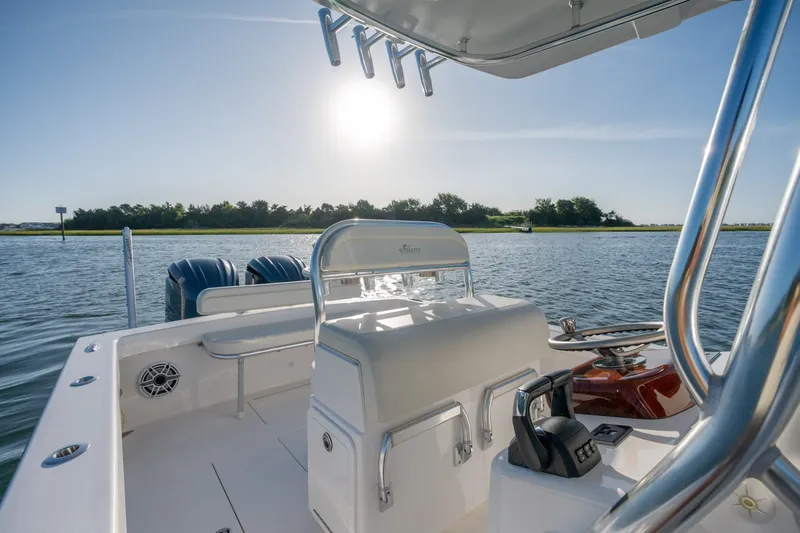 Slide: The Image of 2023 Stuart 27 Center Console boat on calm water under bright sun. - 18
