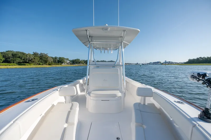 Slide: The Image of 2023 Stuart 27 Center Console boat on calm water, featuring spacious seating and sleek design. - 33