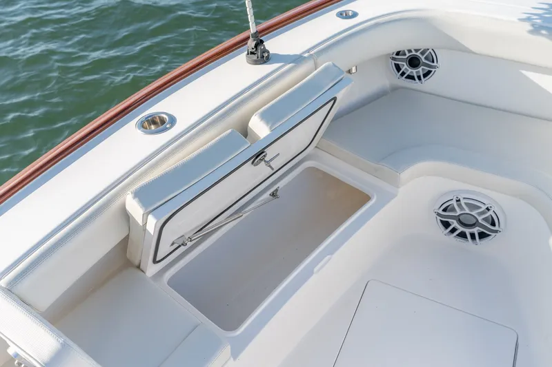 Slide: The Image of 2023 Stuart 27 Center Console boat interior with storage compartment and speaker. - 28