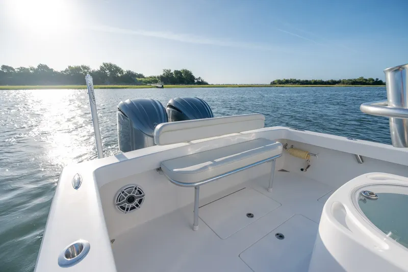 Slide: The Image of 2023 Stuart 27 Center Console boat on calm water, featuring dual engines and sleek design. - 19