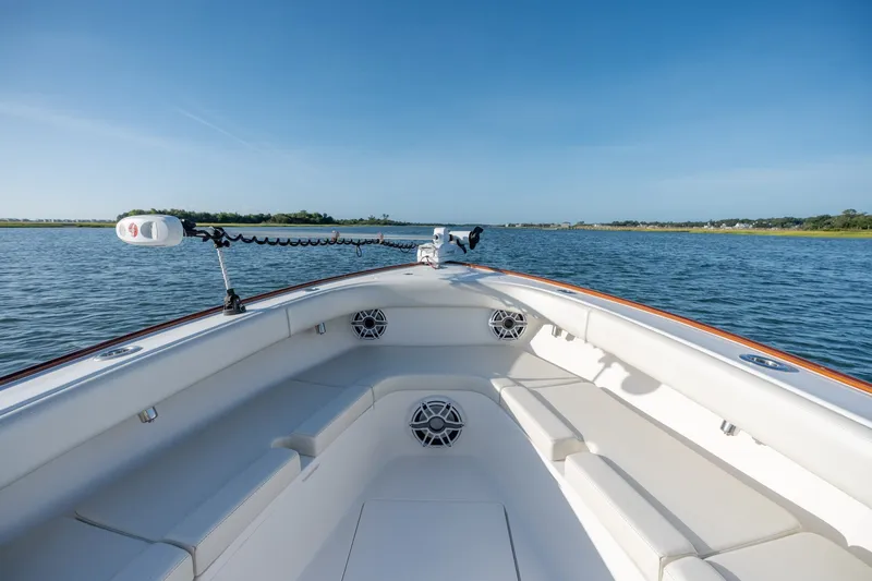 Slide: The Image of 2023 Stuart 27 Center Console boat on calm water, featuring spacious seating and modern design. - 26