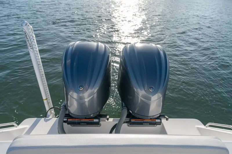 Slide: The Image of Twin Yamaha outboard engines on 2023 Stuart 27 Center Console boat in sunlight. - 23