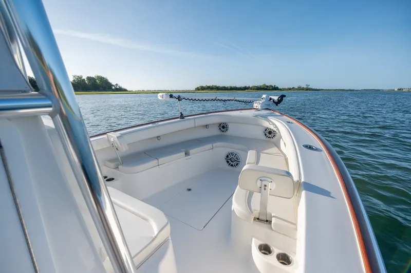 Slide: The Image of 2023 Stuart 27 Center Console boat on calm water, featuring spacious seating. - 25