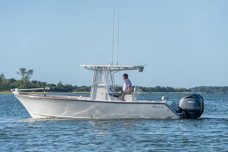 Slide: The Image of 2023 Stuart 27 Center Console boat cruising on calm water with Yamaha engine. - 1