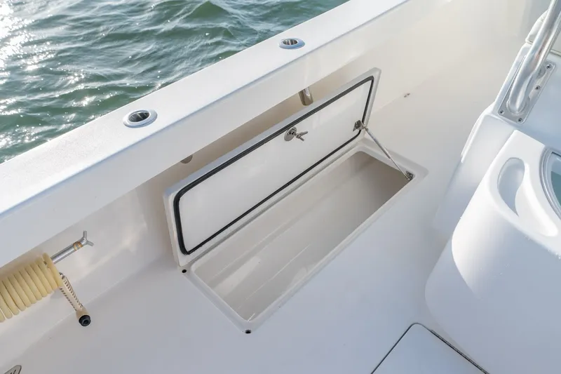 Slide: The Image of 2023 Stuart 27 Center Console boat with open storage compartment on deck. - 36