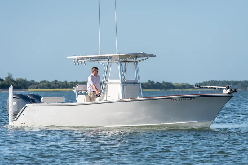 Slide: The Image of 2023 Stuart 27 Center Console boat cruising on calm water. - 2