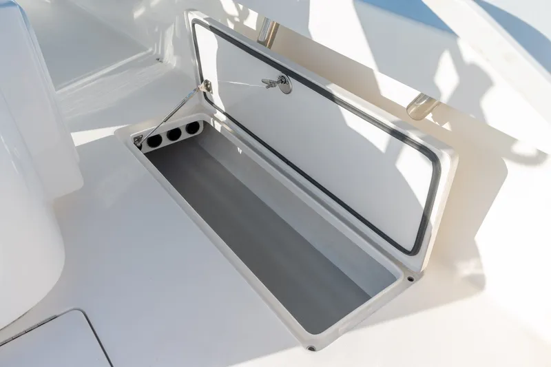 Slide: The Image of Open storage compartment on 2023 Stuart 27 Center Console boat. - 38