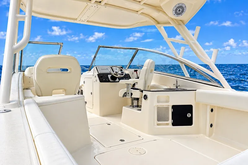 Slide: The Image of 2015 Scout 245 Dorado boat interior with helm, seats, and ocean view. - 3