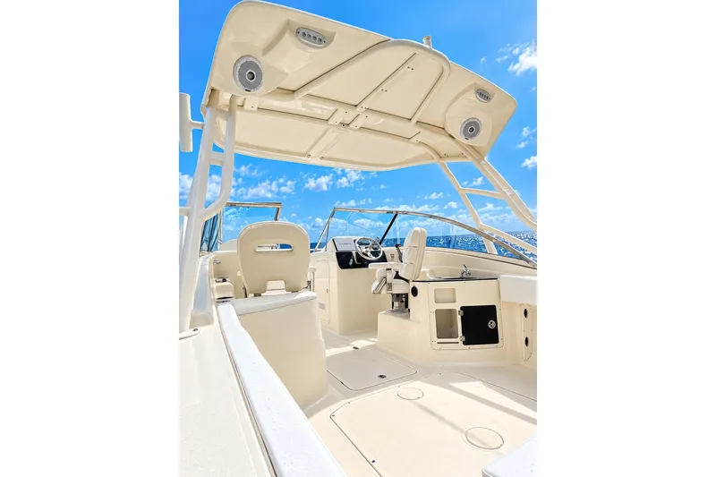 Slide: The Image of 2015 Scout 245 Dorado boat interior with helm, seating, and blue sky background. - 10