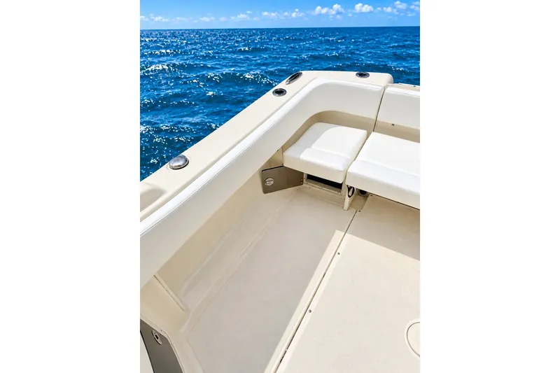 Slide: The Image of 2015 Scout 245 Dorado boat interior with ocean view, featuring comfortable seating. - 7