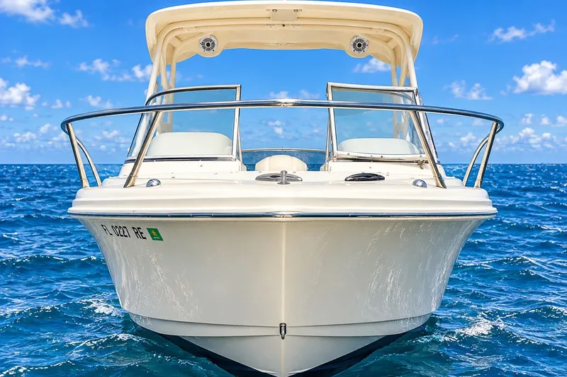 Slide: The Image of 2015 Scout 245 Dorado boat on open ocean under clear blue sky. - 2