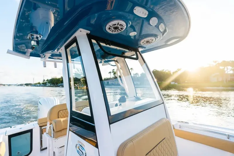 Slide: The Image of 2027 Sportsman Open 212 Center Console boat on water at sunset. - 8