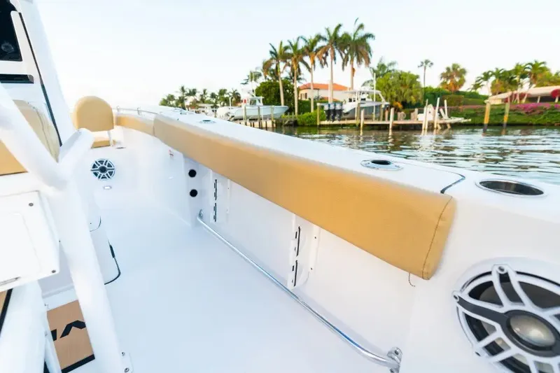 Slide: The Image of 2027 Sportsman Open 212 Center Console boat interior with tan seating, dockside view. - 9