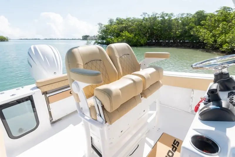 Slide: The Image of 2027 Sportsman Open 212 Center Console boat interior with dual seats and steering wheel. - 2