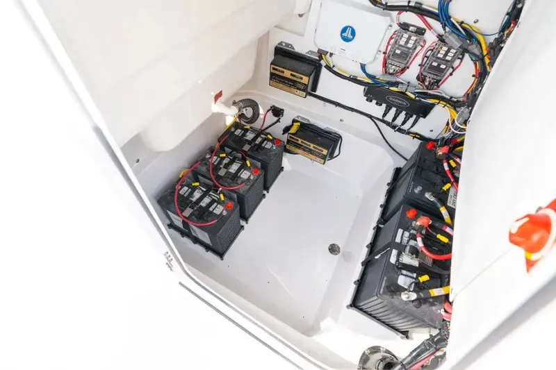 Slide: The Image of Battery compartment of 2027 Sportsman Open 212 Center Console boat, showcasing wiring and equipment. - 10
