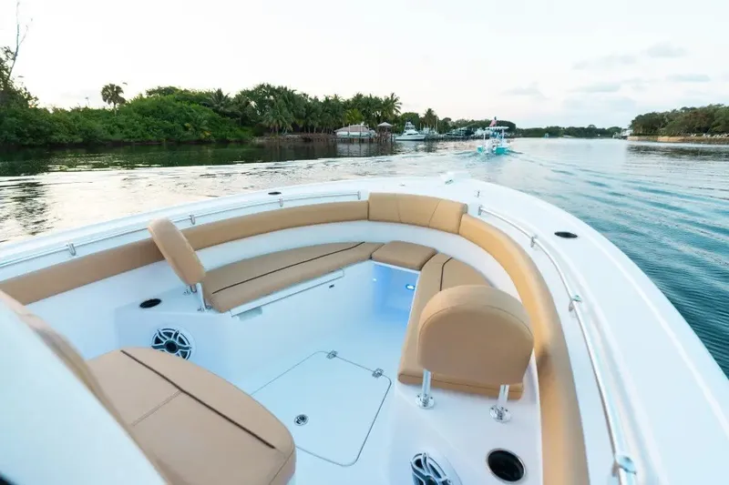 Slide: The Image of 2027 Sportsman Open 212 Center Console boat with tan seating on calm water. - 5