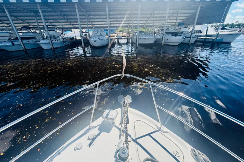 Slide: The Image of Bow view of 2000 Sea Ray 410 Sundancer docked in a marina. - 24