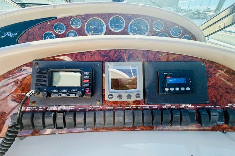 Slide: The Image of Control panel of a 2000 Sea Ray 410 Sundancer boat with navigation instruments. - 40