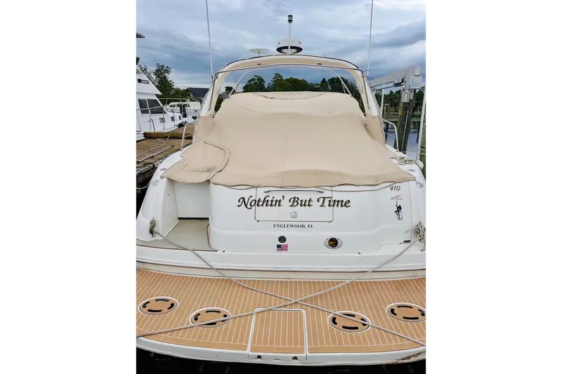 Slide: The Image of 2000 Sea Ray 410 Sundancer yacht docked, covered, with "Nothin' But Time" on the stern. - 72
