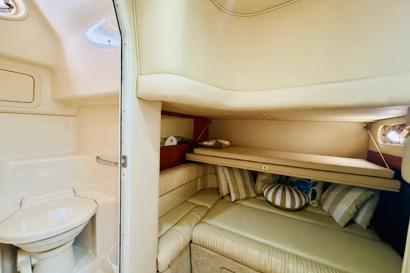 Slide: The Image of Interior cabin of 2000 Sea Ray 410 Sundancer with cozy seating and compact bathroom. - 66