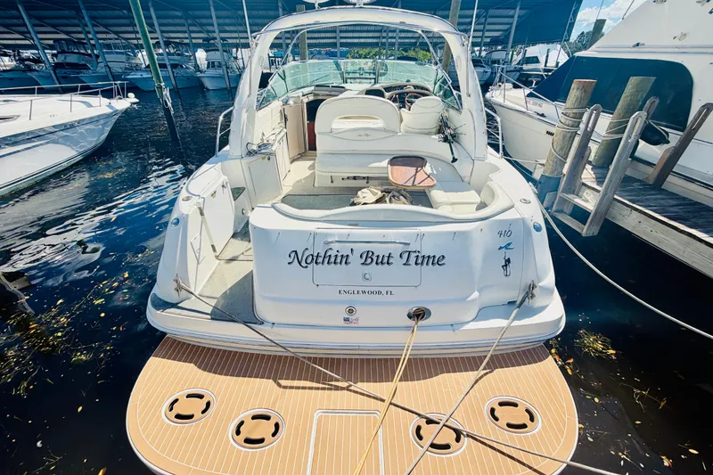 Slide: The Image of 2000 Sea Ray 410 Sundancer docked, rear view with "Nothin' But Time" name visible. - 56