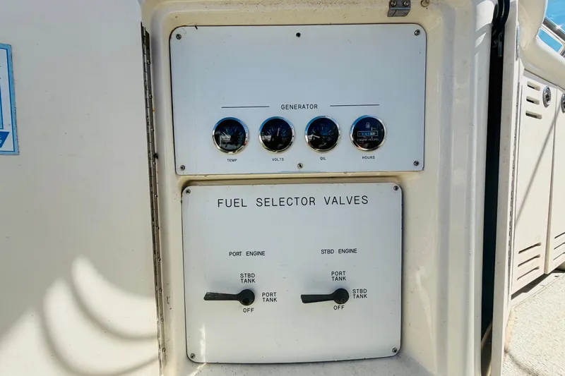 Slide: The Image of Control panel of a 2000 Sea Ray 410 Sundancer with fuel selector valves and gauges. - 35