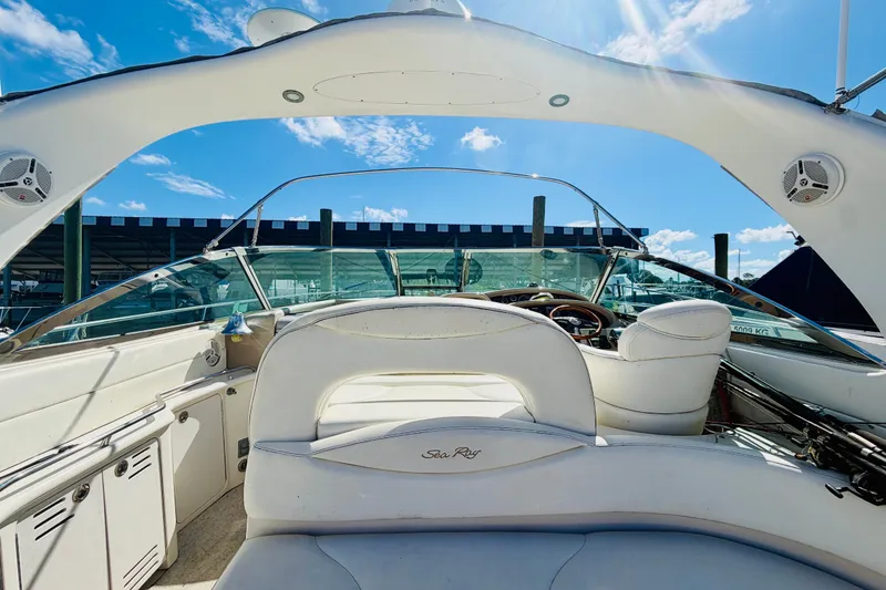 Slide: The Image of 2000 Sea Ray 410 Sundancer yacht interior with white seating and clear blue sky. - 14