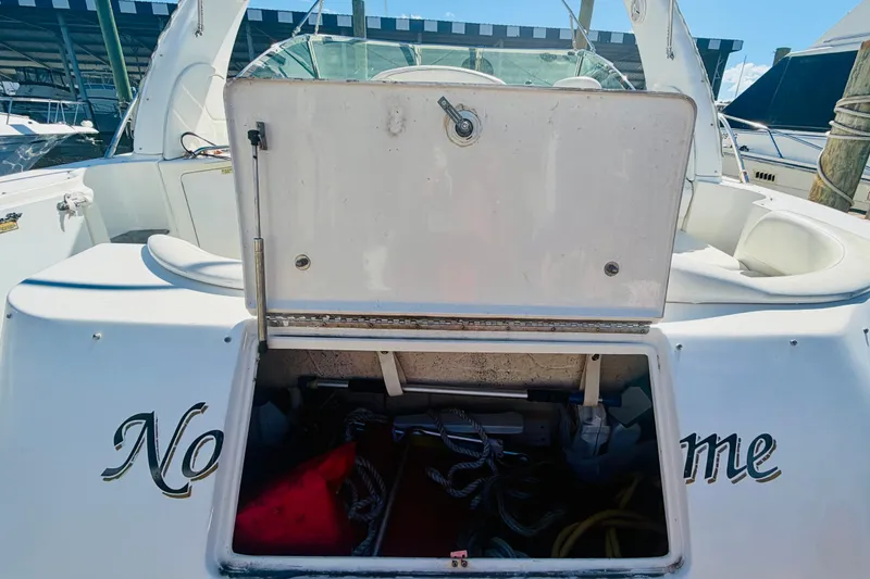 Slide: The Image of Open storage compartment on a 2000 Sea Ray 410 Sundancer boat docked at a marina. - 9