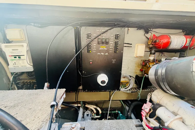 Slide: The Image of Engine room of 2000 Sea Ray 410 Sundancer with control panel and fire extinguisher. - 51