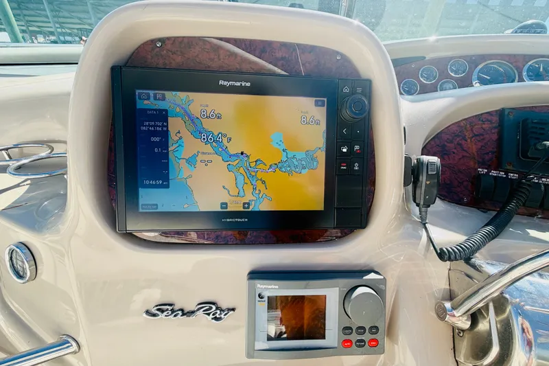 Slide: The Image of Dashboard of a 2000 Sea Ray 410 Sundancer with navigation system and controls. - 43