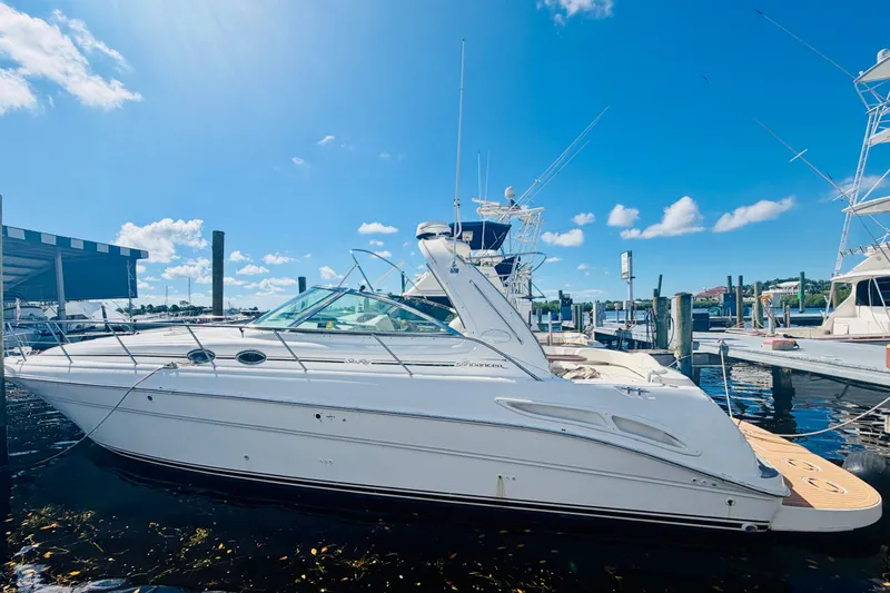 Slide: The Image of 2000 Sea Ray 410 Sundancer yacht docked under clear blue sky. - 57