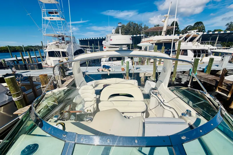 Slide: The Image of 2000 Sea Ray 410 Sundancer yacht docked at a marina under a clear blue sky. - 31