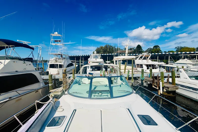 Slide: The Image of 2000 Sea Ray 410 Sundancer docked at marina under clear blue sky. - 30