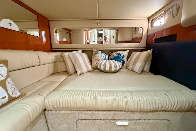 Slide: The Image of Luxurious interior of 2000 Sea Ray 410 Sundancer with plush seating and decorative pillows. - 63