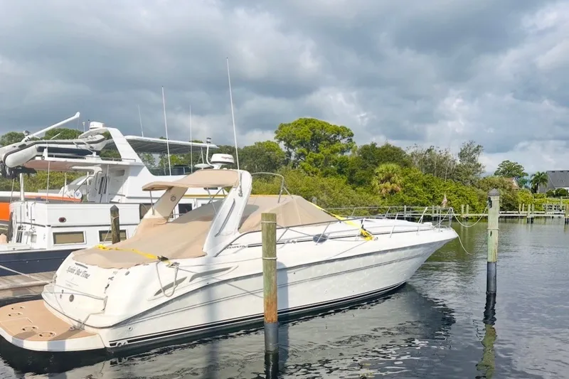 Slide: The Image of 2000 Sea Ray 410 Sundancer yacht docked at a marina under cloudy skies. - 70