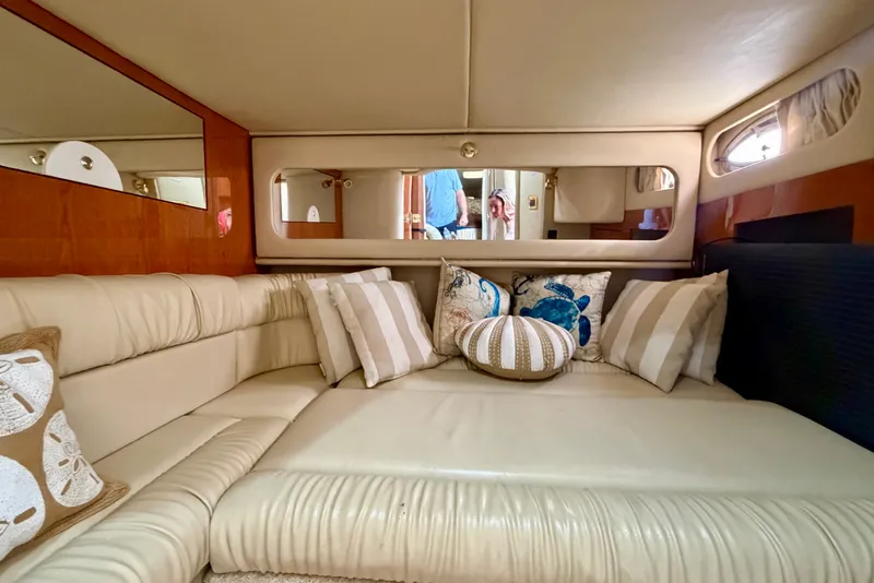 Slide: The Image of Luxurious interior of 2000 Sea Ray 410 Sundancer yacht with plush seating and decorative pillows. - 62
