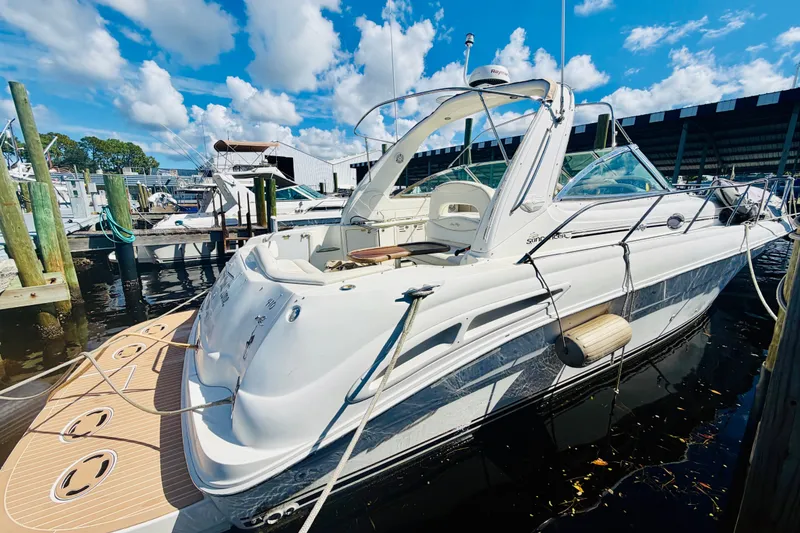 Slide: The Image of 2000 Sea Ray 410 Sundancer yacht docked at marina under blue sky. - 6